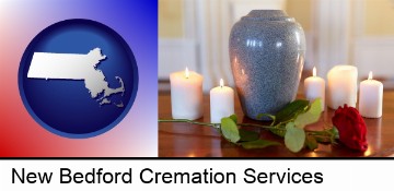 cremation urn with red rose and burning candles in New Bedford, MA