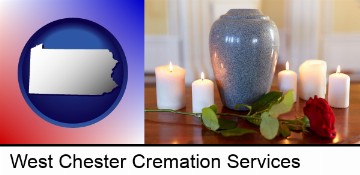 cremation urn with red rose and burning candles in West Chester, PA