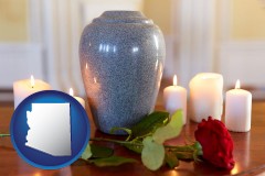 arizona map icon and cremation urn with red rose and burning candles