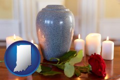 indiana map icon and cremation urn with red rose and burning candles