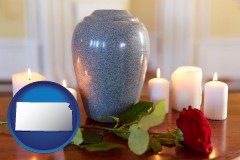 kansas map icon and cremation urn with red rose and burning candles