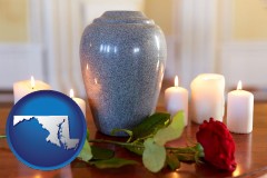 maryland map icon and cremation urn with red rose and burning candles