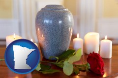 minnesota map icon and cremation urn with red rose and burning candles