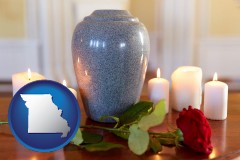 missouri map icon and cremation urn with red rose and burning candles