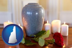 new-hampshire map icon and cremation urn with red rose and burning candles