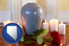 nevada map icon and cremation urn with red rose and burning candles