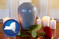 new-york map icon and cremation urn with red rose and burning candles