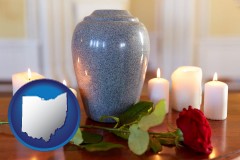 cremation urn with red rose and burning candles - with OH icon