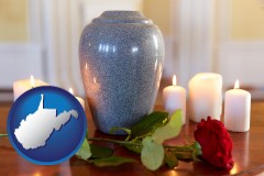 west-virginia map icon and cremation urn with red rose and burning candles