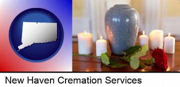 cremation urn with red rose and burning candles in New Haven, CT