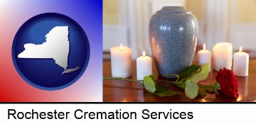 cremation urn with red rose and burning candles in Rochester, NY