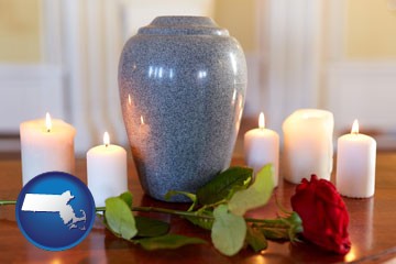 cremation urn with red rose and burning candles - with Massachusetts icon